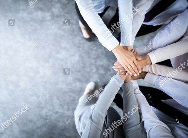 stock-photo-unity-and-teamwork-business-people-putting-their-hands-together-top-view-copy-space-1282734733.jpg